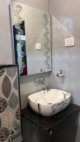 a bathroom with a sink and a mirror at Last Minute Deal @ Hotel Sunset in Orchha