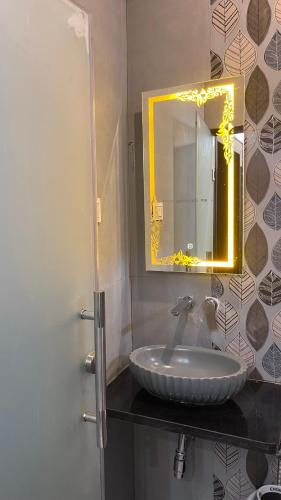 a bathroom with a sink and a mirror at Last Minute Deal @ Hotel Sunset in Orchha