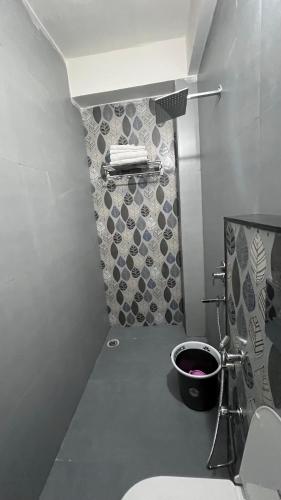a small bathroom with a toilet and a wall at Last Minute Deal @ Hotel Sunset in Orchha
