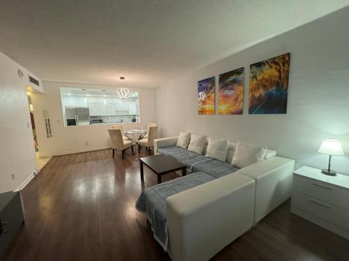 a living room with a white couch and a table at Family Stay Ocean Reserve Resort Sunny Isles in Sunny Isles Beach