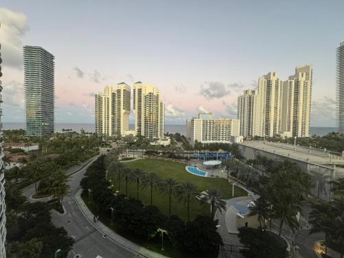 a view of a city with tall buildings and palm trees at Family Stay Ocean Reserve Resort Sunny Isles in Sunny Isles Beach