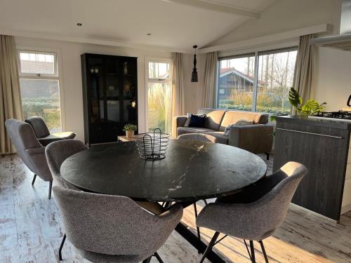 a living room with a black table and chairs at Diek42 in Kattendijke