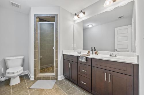 a bathroom with a sink and a toilet and a shower at Garage w/ Veranda & Washer + Dryer in Atlanta