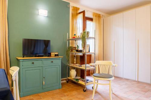 a living room with a blue cabinet and a tv at A casa di Francesco in Santa Maria degli Angeli
