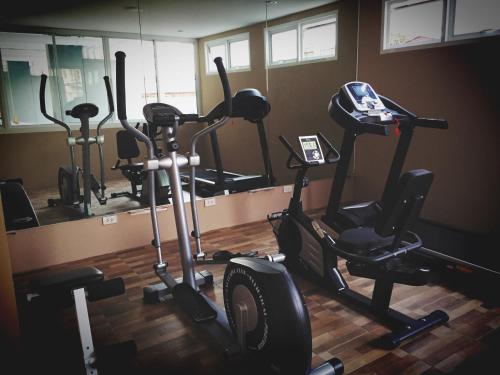 a gym with several exercise bikes and a mirror at The Bedroom Ladprao 101 Bangkok - SHA in Bangkok