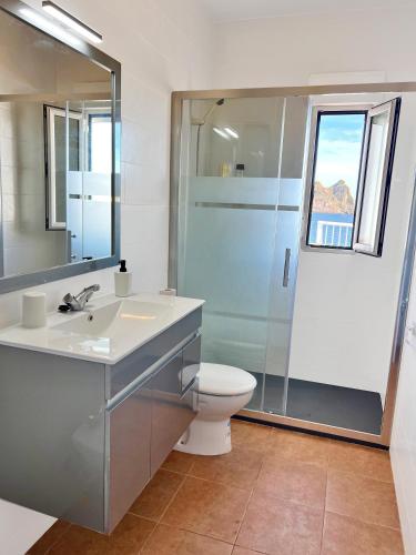 a bathroom with a toilet and a sink and a shower at La Paloma, Chalet a pie de playa in Águilas