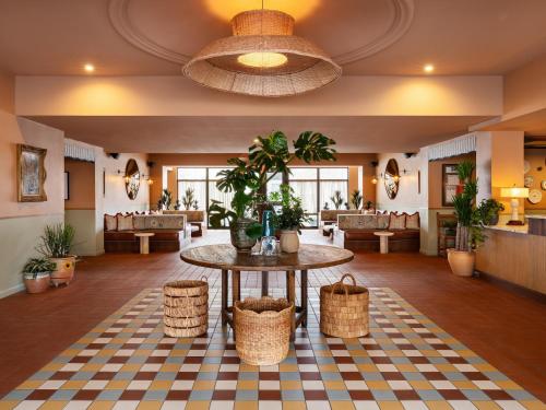 a lobby with a table and baskets on the floor at ARRIVE Albuquerque in Albuquerque