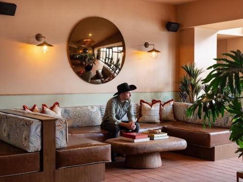 a man sitting on a couch in a living room at ARRIVE Albuquerque in Albuquerque