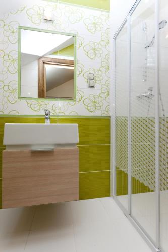 a bathroom with a sink and a mirror at DW California in Rewal