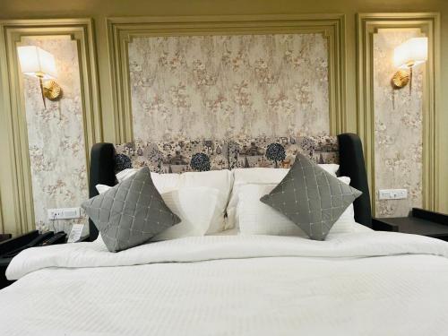 a large white bed with pillows in a bedroom at Krishna Resort Pushkar in Pushkar