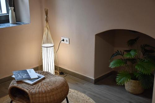 a living room with a lamp and a wicker chair at Armonia in Samothráki