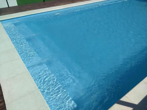 a blue swimming pool with water in it at Departamento centro Carlos Paz in Villa Carlos Paz