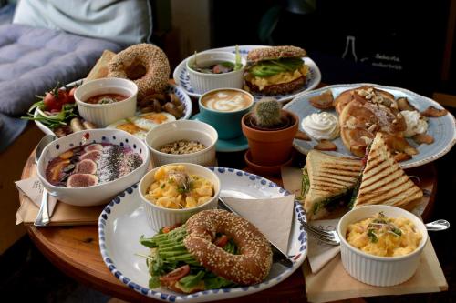a table filled with different types of food on plates at BALANCE apartments in Znojmo