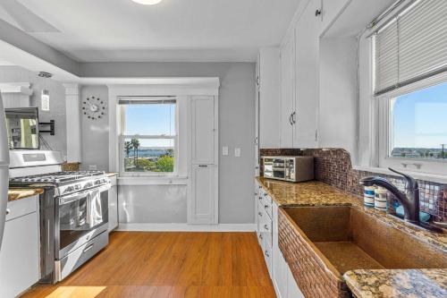 a kitchen with a sink and a counter top at Bankers Hill Hideaway with AC Views and Parking in San Diego