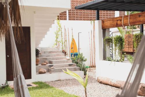 a staircase in a house with a surfboard on the wall at Casa Kâi in Brisas de Zicatela
