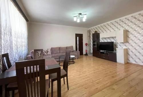 a living room with a table and a dining room at Yeraz Stay in Yerevan