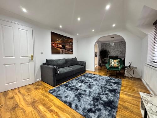 a living room with a couch and a rug at A luxurious coach house in Colchester