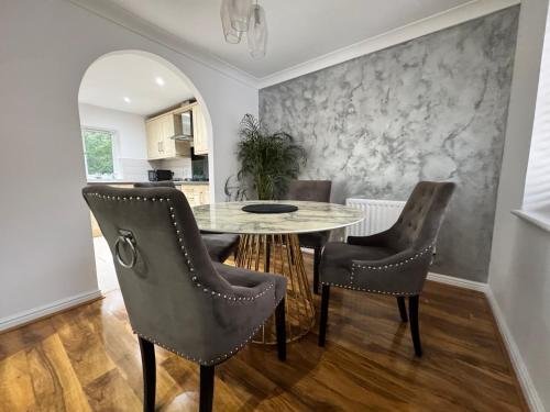 a dining room with a table and chairs at A luxurious coach house in Colchester