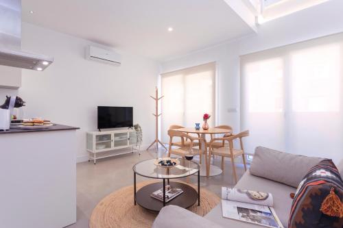 a living room with a couch and a table at Apartamentos Costa Tropical by Rent Me in Motril