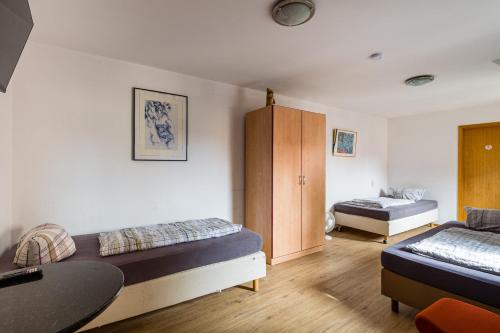 a room with two beds and a table in it at Enjoy your stay with DKN apartments - Mon-Sun - Late night check-in - Multilanguage - Near Railway station - Witamy serdecznie in Halle an der Saale