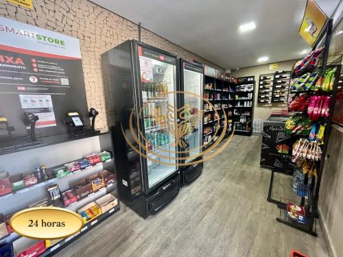 a store aisle with a large machine in a store at Coruja Imob - Flat Crystal Place in Goiânia