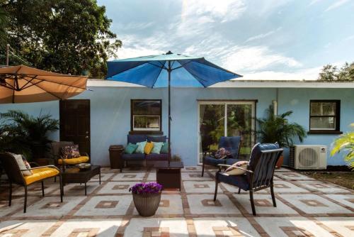 a patio with chairs and an umbrella at Casa Azul in Sarasota