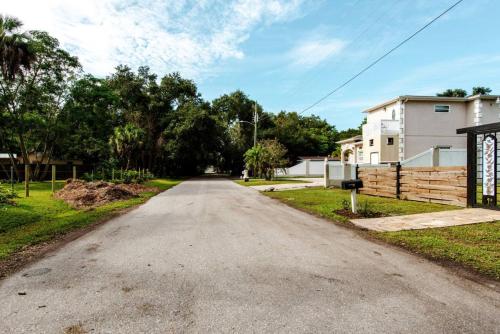 an empty road in a residential neighborhood with trees at Casa Azul in Sarasota