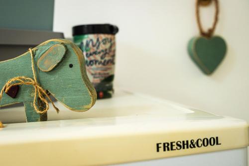 a toy elephant sitting on top of a fridge at Ria's Rest Self Catering Flatlet in Sedgefield