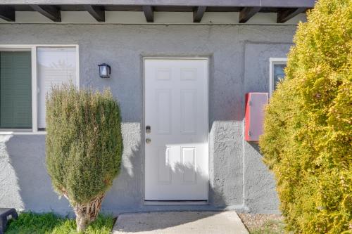 a house with a white door and two bushes at 6 Mi to Frazier Mountain Cozy Studio Retreat in Frazier Park