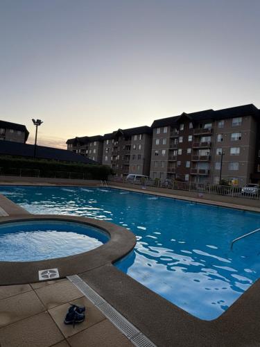 a large swimming pool in front of some buildings at PARQUE AL VOLCAN VILLARRICA in Villarrica