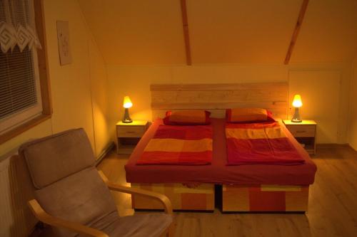 a bedroom with a bed and a chair and two lamps at Privát Zuzana in Jablonec nad Jizerou