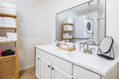 a bathroom with a sink and a mirror at Comfy Duplex w 2 Kings Sofa Bed in Maryville