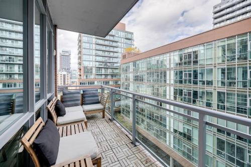 a balcony with chairs and a view of a city at Studio Gem in the lovely Waterfront Communities in Toronto