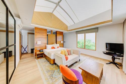 a bedroom with a bed and a flat screen tv at Cinnamon Hakuraa Huraa Maldives - All Inclusive in Meemu Atoll