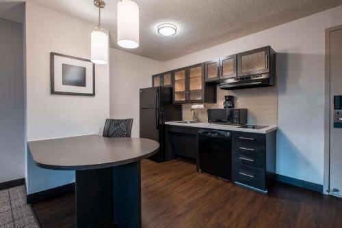 a kitchen with a table and a counter top at Sonesta Simply Suites Dallas Richardson in Dallas