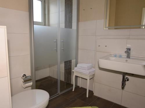 a bathroom with a toilet and a sink at Ferienhaus ,Felix' in Heiligenhafen