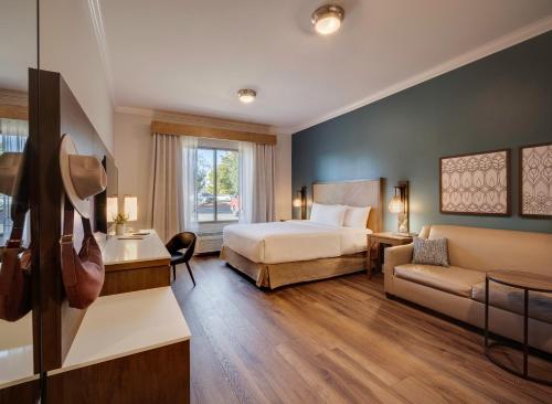 a hotel room with a bed and a couch at Ayres Hotel Chino Hills Ontario in Chino Hills