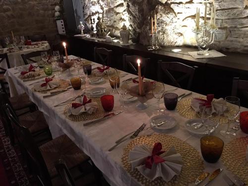 a table with a white table cloth and candles on it at B&B Puccini in Pescaglia