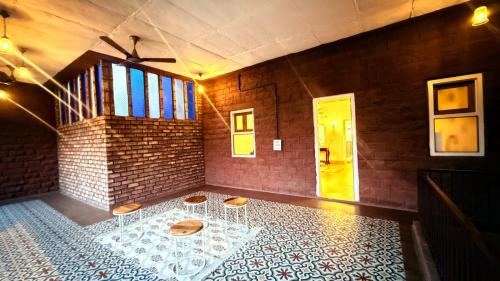 a room with a table and a brick wall at The Munshi Mansion in Jodhpur