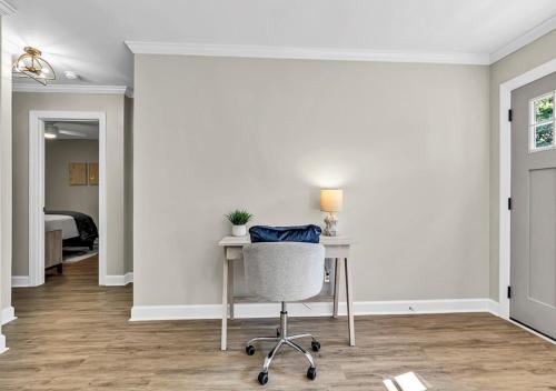 an empty room with a desk and a chair at 15% off! Front porch w/ Wi-Fi & Private Parking in Gibsonville