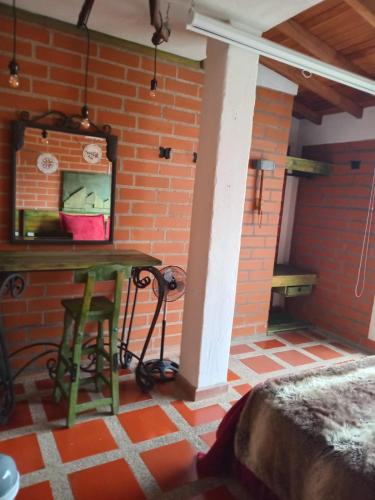 a room with a table and a brick wall at Hotel Spa Bliss Guatape in Guatapé