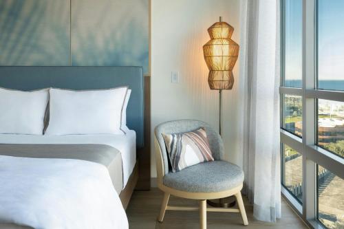 a bedroom with a bed and a chair and a window at The Westin Tampa Bay in Tampa