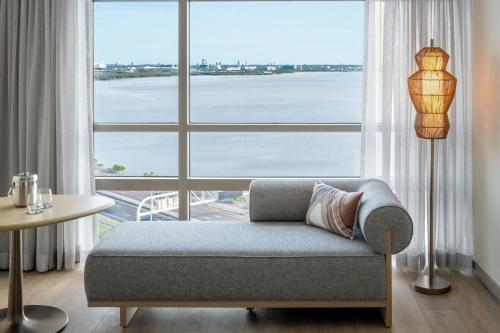 a living room with a couch and a large window at The Westin Tampa Bay in Tampa