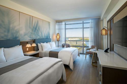 a hotel room with two beds and a television at The Westin Tampa Bay in Tampa