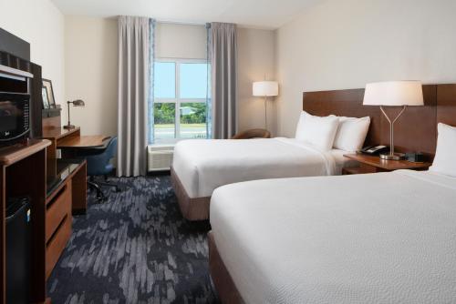 a hotel room with two beds and a television at Fairfield Inn & Suites by Marriott Destin in Destin