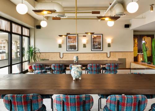 a dining room with a large wooden table and chairs at ARRIVE Albuquerque in Albuquerque