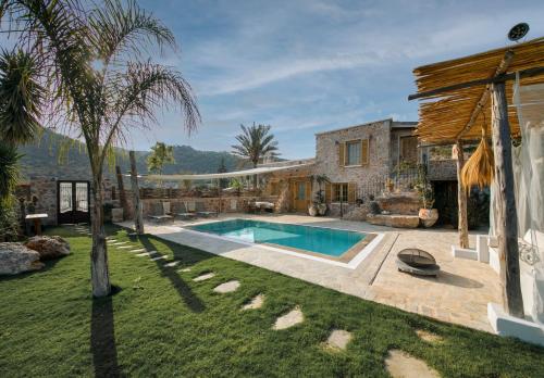 a house with a swimming pool in a yard at Kassandra Heritage in Fethiye