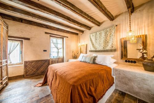 a bedroom with a large bed in a room at Kassandra Heritage in Fethiye