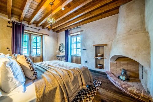 a bedroom with a large bed and a fireplace at Kassandra Heritage in Fethiye