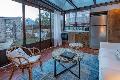 a kitchen with a couch and a table in a room at Kassandra Heritage in Fethiye
